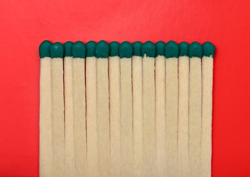 Matches isolated on a red textured background.