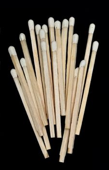 A bunch of wooden matches isolated on a black background