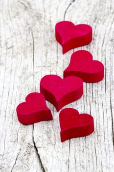 red hearts on old wooden background