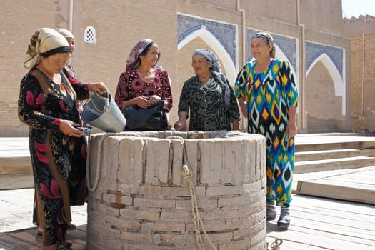 Five old Usbek women standing around an on well, photo taken in Samarkand, Uzbekistan, Central Asia