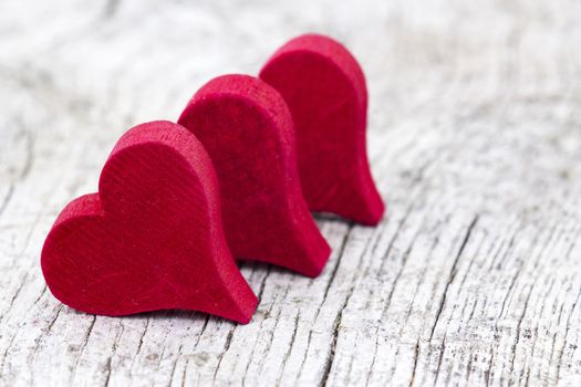 red hearts on old wooden background