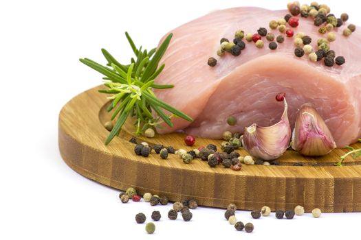 turkey meat on wooden board with various herbs and spices