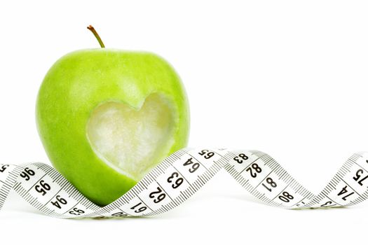 green apple with a measuring tape and heart symbol isolated on white background 