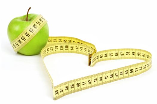 Tape measure heart shape and green apple  - health, weight concept 