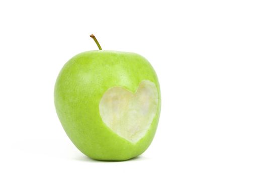 Fresh green apple with cut off heart shape on white background