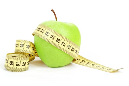 Green apple and yellow measuring tape isolated on white background