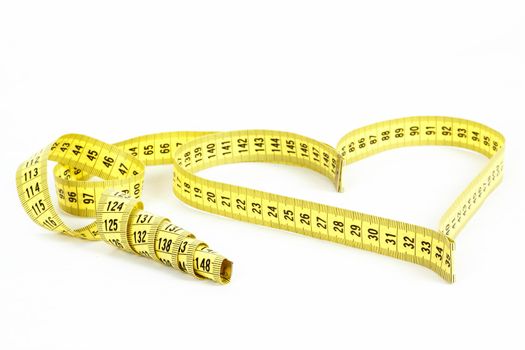A measuring tape shaping a heart isolated on white background