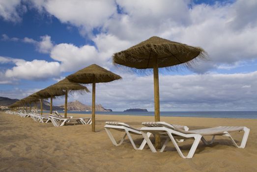 Sun loungers and parasols on the beach at Porto Santo, Portugal