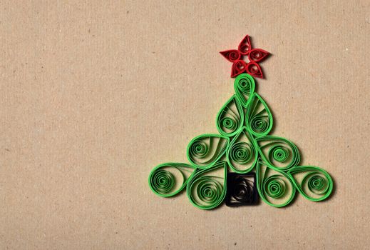 Handmade Christmas tree cut out from paper. Quilling.