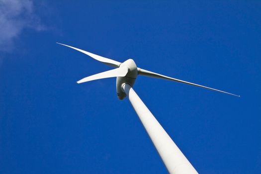 Windmill against a blue sky, alternative energy source