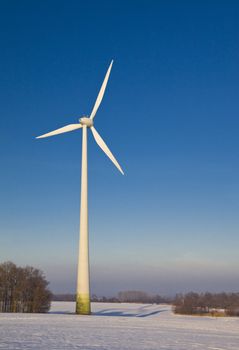 Windmill against a blue sky in winter, alternative energy source