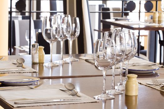 Glasses and plates on table in restaurant