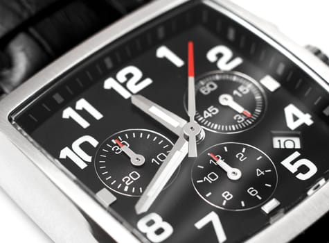 Modern steel chronograph wristwatch closeup time concept
