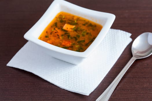 Chicken soup in the white ceramic bowl