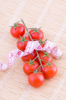 Small bunch of tomatoes with measure fitness tape