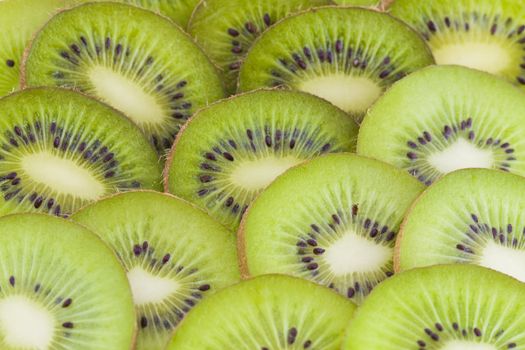 Fresh kiwi slices, green fruits background