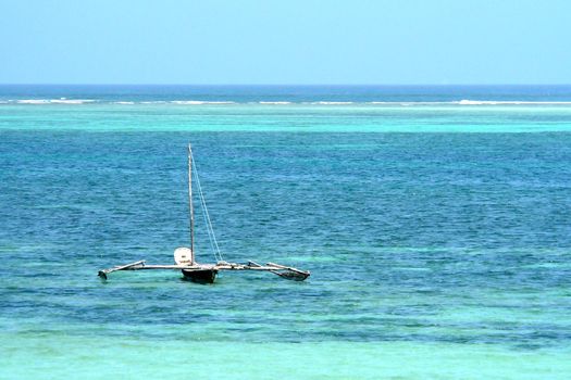 Outrigger canoe in tropical waters of Kenya