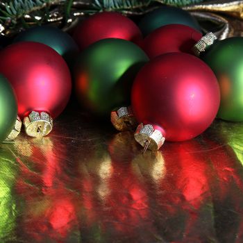 Colorful Christmas baubles in red and green with reflection