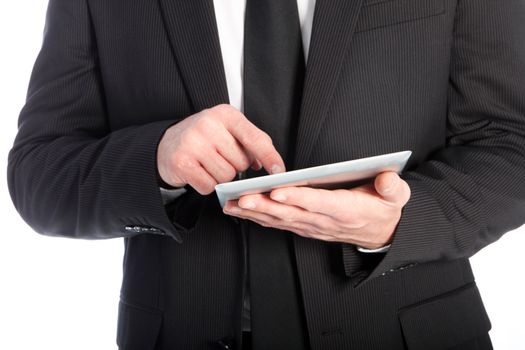 Cropped view of the hands and torso of a businessman in a suit using his finger to scroll on the touch screen of a tablet isolated on white
