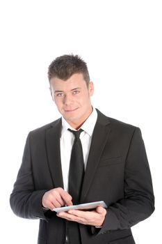 Handsome young businessman using a handheld tablet computer looking up at the camera, upper body isolated studio portrait