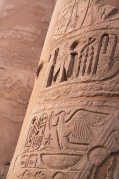 Ancient hieroglyphics on stone column in Karnak in Egypt