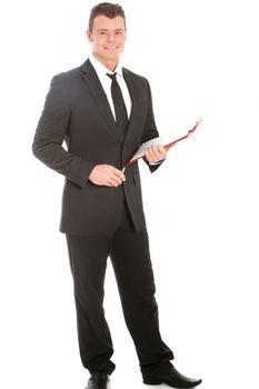 Full length studio portrait of a friendly smiling businessman with a clipboard wearing a stylish dark suit isolated on white