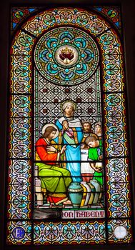 Stained glass window Jesus Mary turning water to wine in Cana basilica inside Monestir Monastery of Montserrat, Barcelona, Catalonia, Spain.  Founded in the 9th Century, destroyed in 1811 when French invaded Spain. Rebuilt in 1844 and now a Benedictine monastery.  Placa de Santa Maria