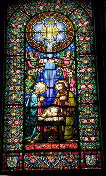 Stained glass nativity baby Jesus Mary Joseph Monestir Monastery of Montserrat, Barcelona, Catalonia, Spain.  Founded in the 9th century, destroyed in 1811 when French invaded Spain. Rebuilt in 1844 and now a Benedictine monastery.  Placa de Santa Maria.