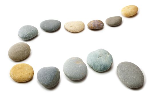 Snaking line of twelve coloured pebbles isolated on white. Clipping path for stones.