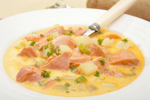 Salmon poached in a creamy broth with potatoes, herbs and celery.