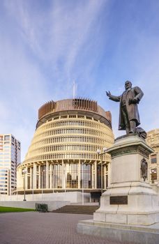 Wellington, The Beehive, New Zealand's Parliament Building, and the statue of Richard John Seddon, New Zealand's longest serving prime minister. The statue, by Sir Thomas Brock (1847-1922) was erected in 1915 and is now out of copyright (50 years from the death of the artist under NZ law).