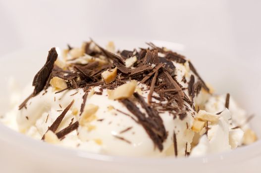 Dessert with cream, chocolate shaving and grated nuts