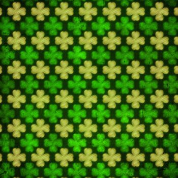 shamrocks - vintage green background with striped flowers over old paper out of focus