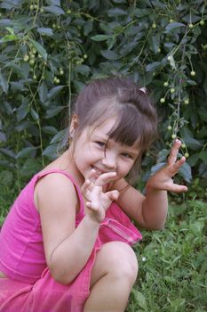 Naughty little girl playing in the garden