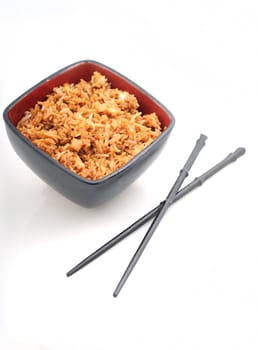Chinese food or fried rice in red bowl with chopsticks