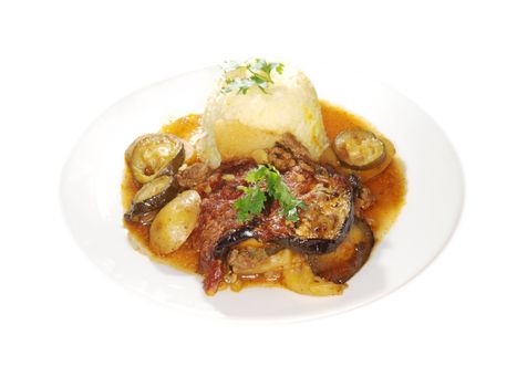 Eggplant dish, fried vegetables in juicy sauce, next to bowl of rice