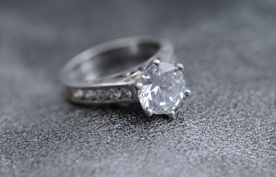 diamond ring on elegant gray leather background