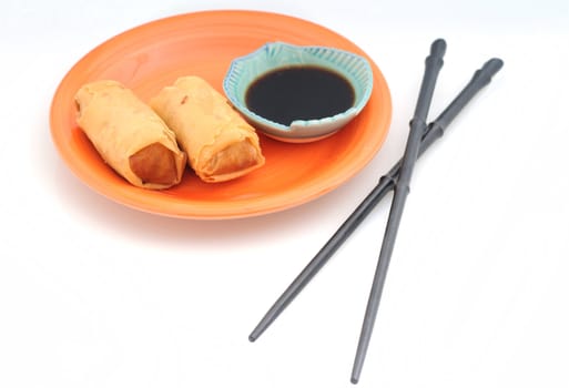 Two spring rolls or egg rolls with chopsticks