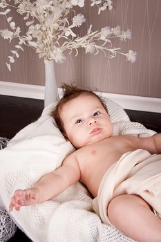 sweet little baby infant toddler on white  blanket in basket at home