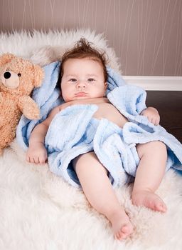 cute little baby todler infant lying on blanket with teddy bear 