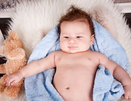 cute little baby todler infant lying on blanket with teddy bear 
