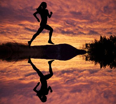Female runner silhouette against the sunset 