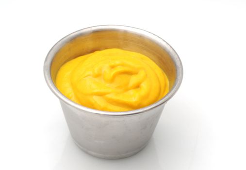 Yellow mustard condiment in a metal container