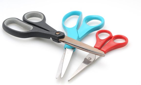 three pairs of scissors in Blue, red and black
