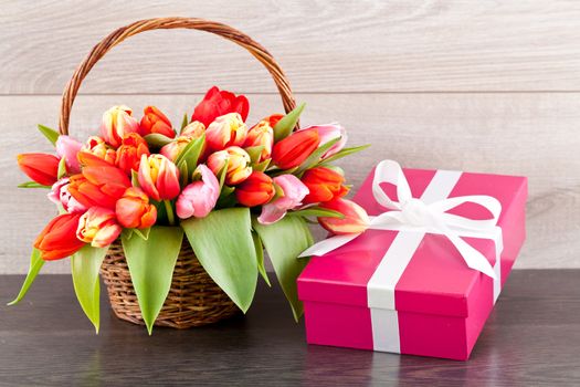 pink present with ribbon and colorful tulips festive easter decoration