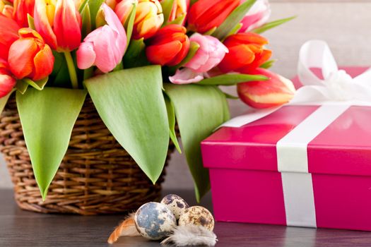 pink present with ribbon and colorful tulips festive easter decoration