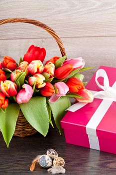 pink present with ribbon and colorful tulips festive easter decoration