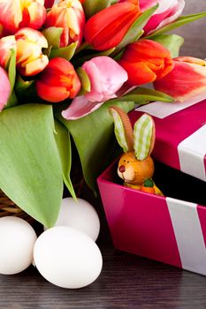 pink present with ribbon and colorful tulips festive easter decoration