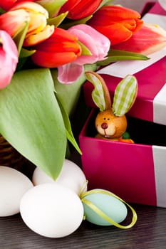 pink present with ribbon and colorful tulips festive easter decoration