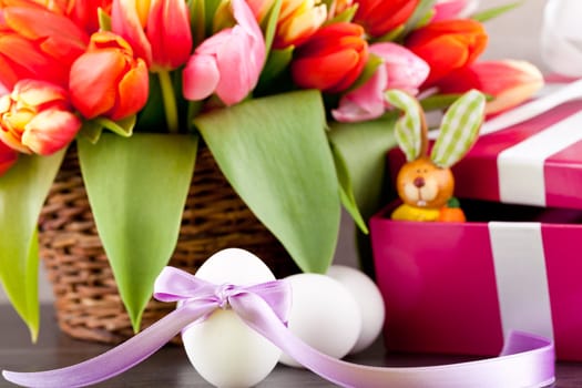 pink present with ribbon and colorful tulips festive easter decoration